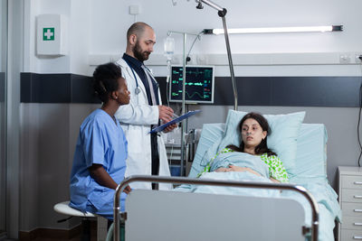 Doctors examining patient at hospital