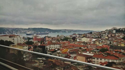 High angle view of houses by sea against sky