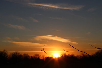 Silhouette of wind turbines at sunset