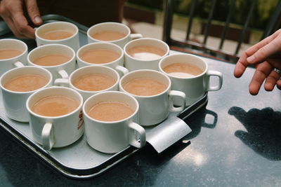 Cropped image of people having tea on table