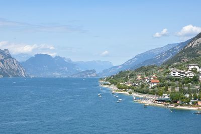 Scenic view of sea and town against sky