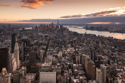 Aerial view of buildings in city during sunset