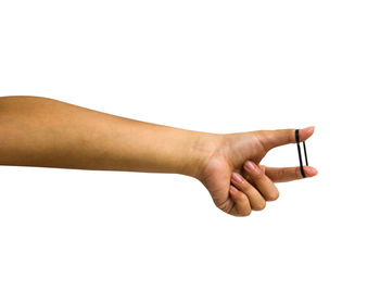 Close-up of hand holding hands over white background