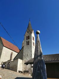 Low angle view of traditional building against clear blue sky