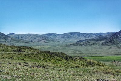 Scenic view of mountains against clear blue sky