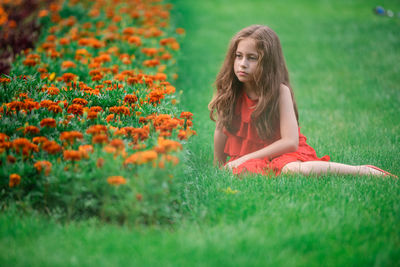 Woman sitting on grassy field