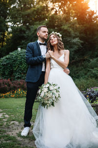 Smiling couple embracing while standing outdoors