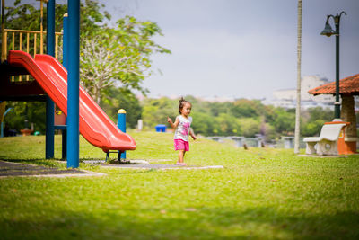 Rear view of girl playing on playground