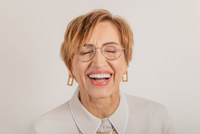 Portrait of young woman against white background