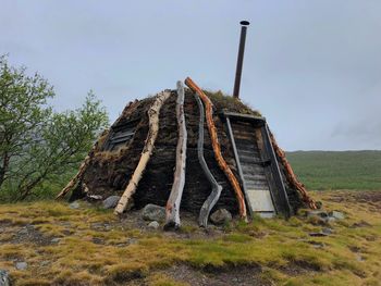 Abandoned built structure on field against sky