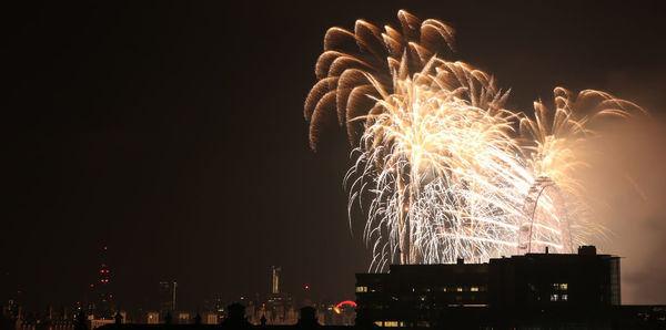 Low angle view of firework display at night