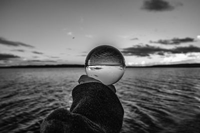 Close-up of hand holding crystal ball