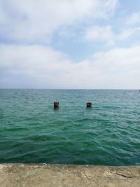 Scenic view of sea against cloudy sky