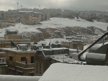 Snow covered buildings in city