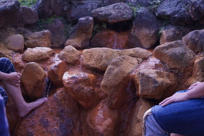 Midsection of woman holding rocks