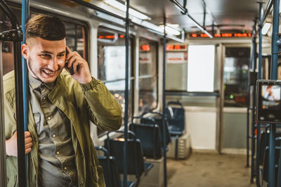 Man reading from mobile phone screen while traveling on metro. wireless internet on public transport