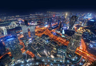 High angle view of city lit up at night