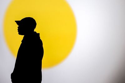 Close-up of silhouette boy against white background