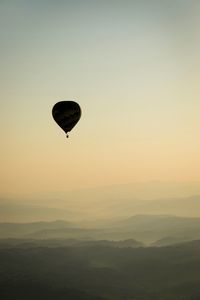 Hot air balloon flying at sunset