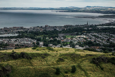 High angle view of townscape by sea against sky