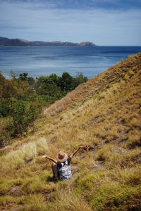 High angle view of woman sitting on mountain