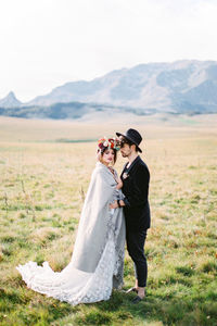 Man and woman standing on field