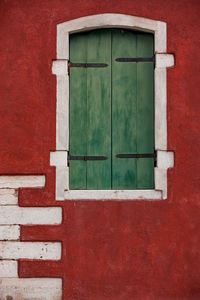 Closed window of red house