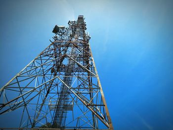 Low angle view of communications tower against sky