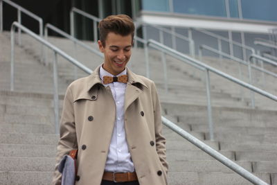 Young man walking on steps