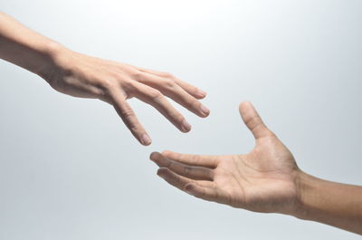 Close-up of hands over white background