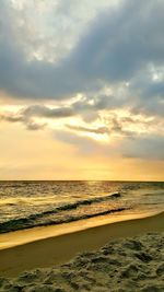 Scenic view of beach against sky during sunset