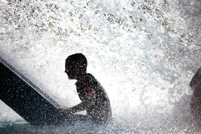 Shadow of man splashing water