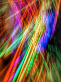 Full frame shot of colorful light painting against black background