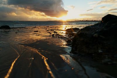 View of calm beach at sunset