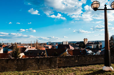 Houses in town against cloudy sky