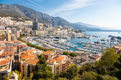 High angle view of townscape by sea against sky