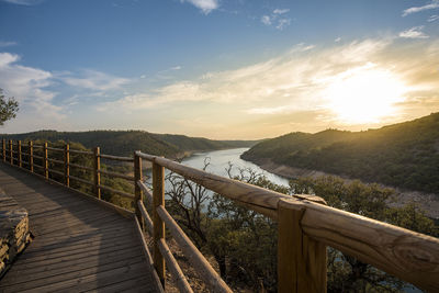 View of river and mountains during sunset