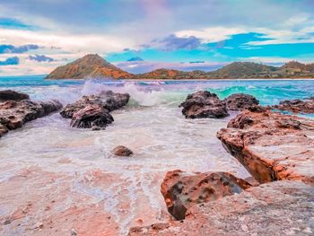 Scenic view of rocks in sea against sky