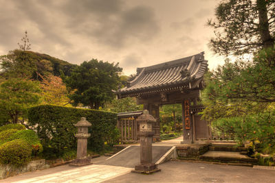 View of temple building against cloudy sky