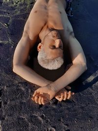 High angle view of shirtless man lying down