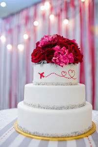 Close-up of roses on cake over table
