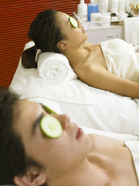 Women having spa treatment while lying on massage table