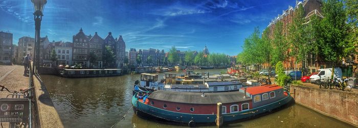 Boats in river with buildings in background