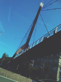 Low angle view of bridge against blue sky