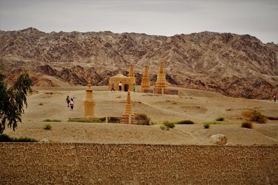 Scenic view of pagoda in desert against sky