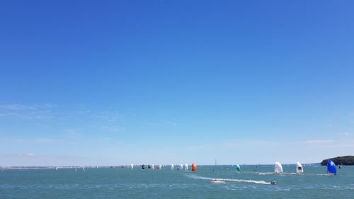 Scenic view of sea against clear blue sky