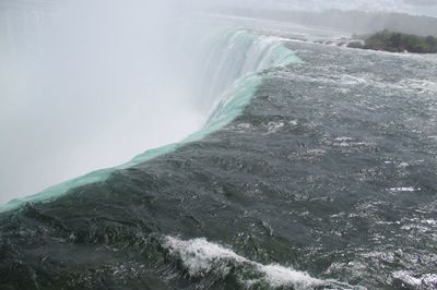 Scenic view of waterfall in foggy weather