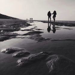 Group of people walking on beach