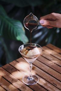 Close-up of wineglass on glass of table