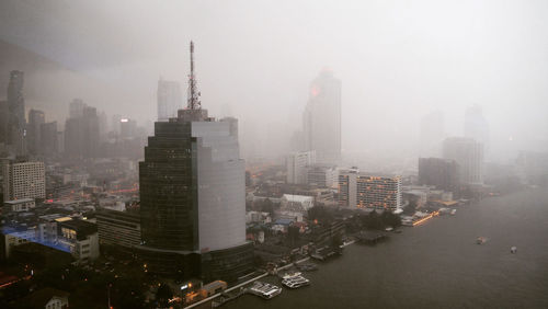 High angle view of modern buildings in city against sky